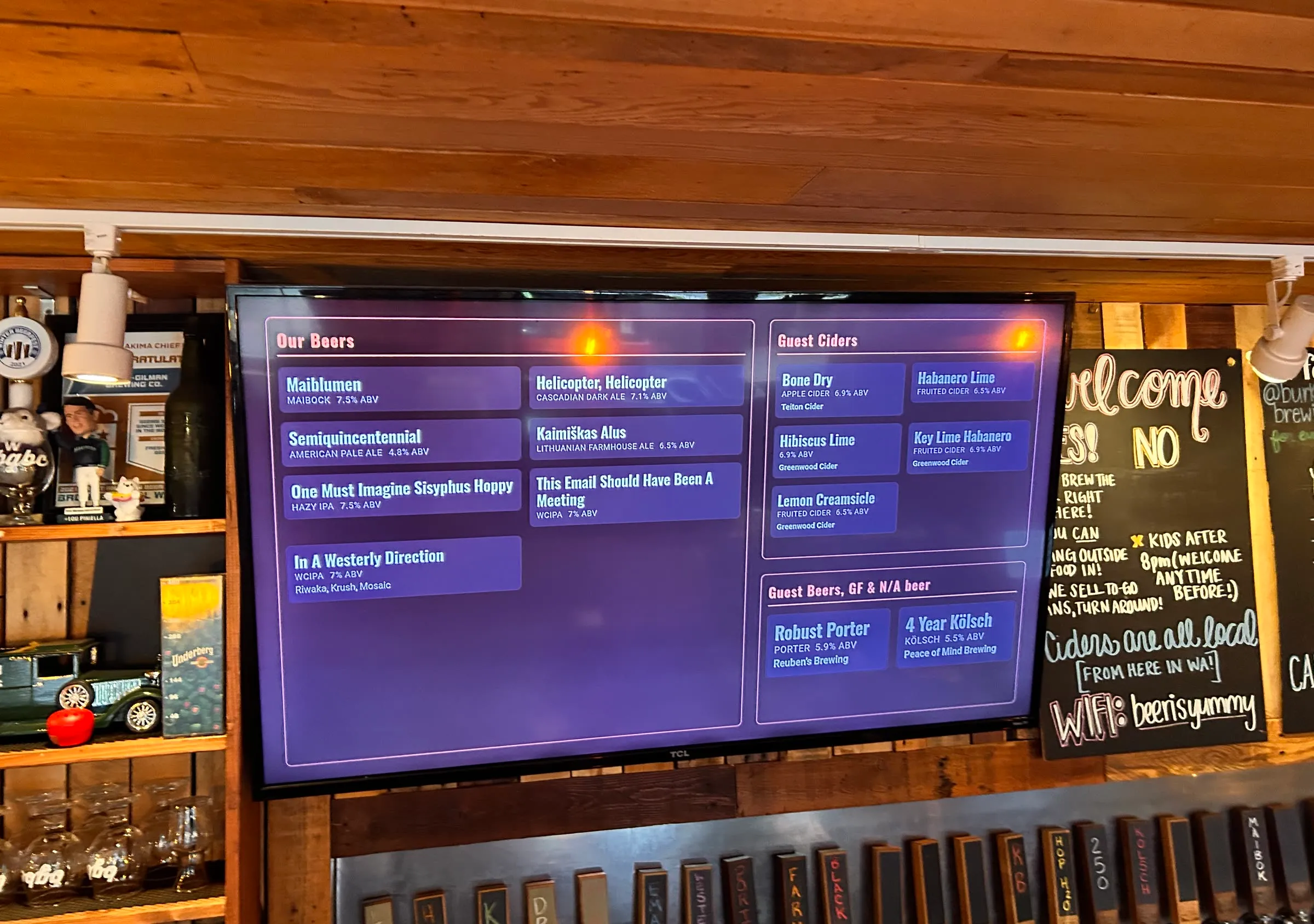 A Menu Tools tap-list display on a wall-mounted TV in a real taproom